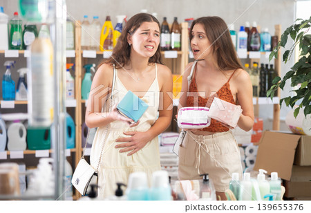 Young women choosing feminine pads in supermarket Young women choosing feminine pads in supermarket 139655376