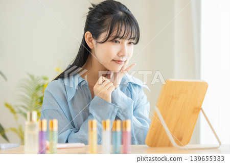 A young lady watching a mirror 139655383