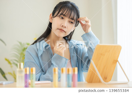 A young lady watching a mirror A young lady watching a mirror 139655384