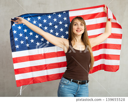 Young cheerful woman holding USA flag 139655528
