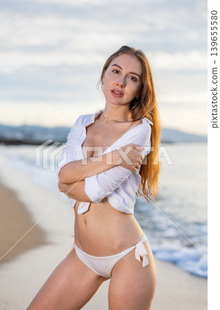 Summer vacation, travel and people concept - young woman on tropical beach over sea and sunset Summer vacation, travel and people concept - young woman on tropical beach over sea and sunset 139655580