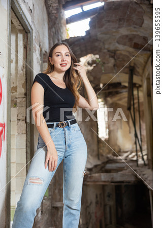 Portrait of smiling attractive woman in abandoned building 139655595