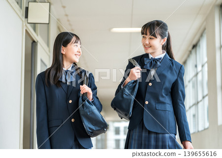 Elementary school students, junior high school students, high school students, and high school girls in uniform walking down the school corridor Elementary school students, junior high school students, high school students, and high school girls in uniform walking down the school corridor 139655616