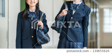 Elementary school students, junior high school students, high school students, and high school girls in uniform walking down the school corridor Elementary school students, junior high school students, high school students, and high school girls in uniform walking down the school corridor 139655620
