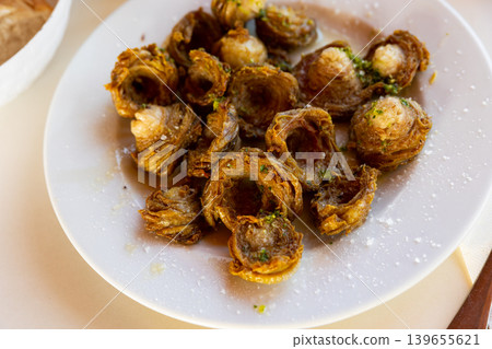 Aragonese Cuisine - fried lamb small iIntestine rings with garlic Aragonese Cuisine - fried lamb small iIntestine rings with garlic 139655621