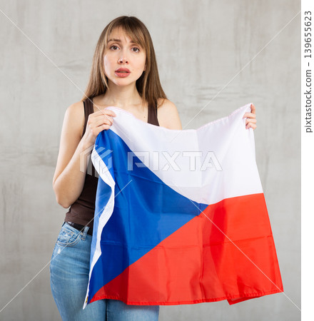 Sad woman posing with flag of Czech Republic in studio Sad woman posing with flag of Czech Republic in studio 139655623