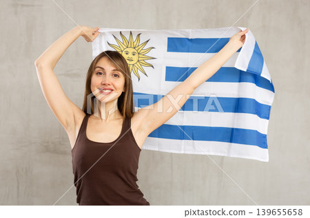 Happy girl with Uruguay flag in her hands Happy girl with Uruguay flag in her hands 139655658