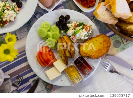 Turkish halal breakfast with cheese, olives, toasted bread, baked potatoes, vegetables Turkish halal breakfast with cheese, olives, toasted bread, baked potatoes, vegetables 139655717