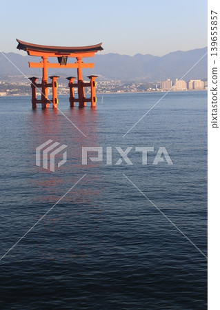 Miyajima, Hatsukaichi City, Hiroshima Prefecture: Itsukushima Shrine - The vibrant vermilion torii gate illuminated by the rising sun. Miyajima, Hatsukaichi City, Hiroshima Prefecture: Itsukushima Shrine - The vibrant vermilion torii gate illuminated by the rising sun. 139655857