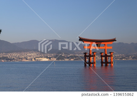 Miyajima, Hatsukaichi City, Hiroshima Prefecture: Itsukushima Shrine - The vibrant vermilion torii gate illuminated by the rising sun. Miyajima, Hatsukaichi City, Hiroshima Prefecture: Itsukushima Shrine - The vibrant vermilion torii gate illuminated by the rising sun. 139655862