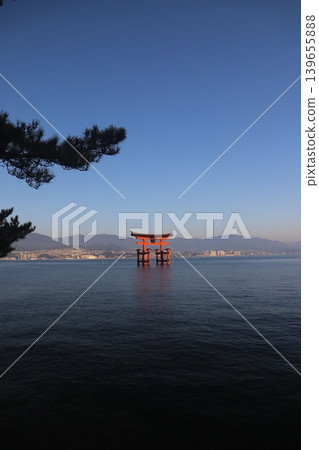 Miyajima, Hatsukaichi City, Hiroshima Prefecture: Itsukushima Shrine - The vibrant vermilion torii gate illuminated by the rising sun. Miyajima, Hatsukaichi City, Hiroshima Prefecture: Itsukushima Shrine - The vibrant vermilion torii gate illuminated by the rising sun. 139655888