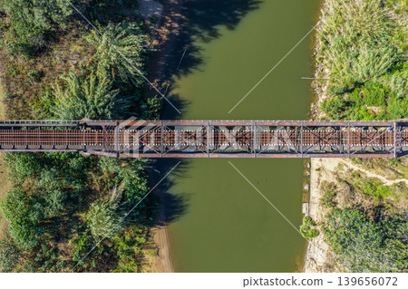 Aerial downward view of the Paterson railway bridge spanning the Hunter River in New South Wales Australia. Drone photograph captures the historic rail bridge crossing the winding river from above Aerial downward view of the Paterson railway bridge spanning the Hunter River in New South Wales Australia. Drone photograph captures the historic rail bridge crossing the winding river from above 139656072