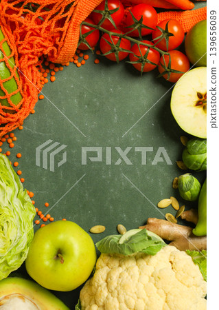 A variety of vegetables and fruits placed on a green surface A variety of vegetables and fruits placed on a green surface 139656089