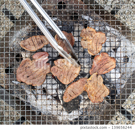 Thick-cut beef tongue grilled over charcoal on a grill outdoors Thick-cut beef tongue grilled over charcoal on a grill outdoors 139656244