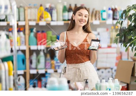 Interested young woman picking beauty products in store 139656287