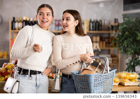 Two women shopping in a store Two women shopping in a store 139656343