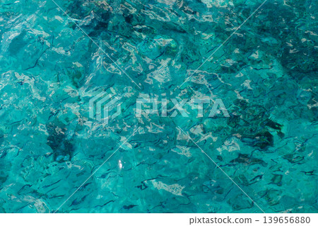 The aquatic environment features sparkling turquoise waters filled with diverse fish, inviting exploration in a peaceful setting. The aquatic environment features sparkling turquoise waters filled with diverse fish, inviting exploration in a peaceful setting. 139656880