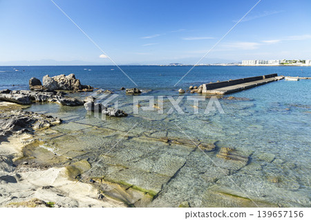 Hayama Isshiki Beach: Rocky shores with Mount Fuji and Enoshima Island in the distance. Hayama Isshiki Beach: Rocky shores with Mount Fuji and Enoshima Island in the distance. 139657156