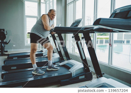 Senior Man Suffering Chest Pain from Possible Heart Condition in Gym Senior Man Suffering Chest Pain from Possible Heart Condition in Gym 139657204