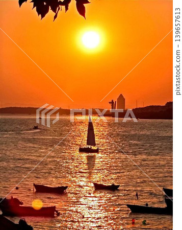 Sunset and sailboats 139657613