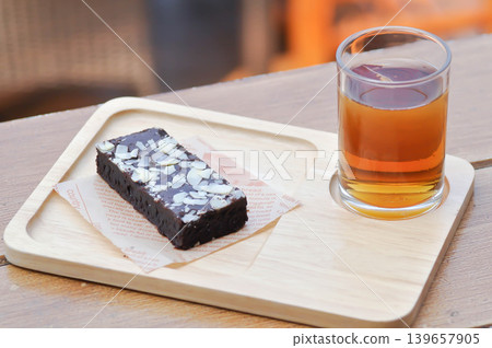 brownie , chocolate cake with almond topping and lemon tea 139657905
