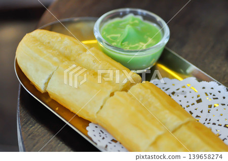 fried dough , deep fried doughstick or Chinese sweetmeat or bun or fried bun or Chinese doughnut fried dough , deep fried doughstick or Chinese sweetmeat or bun or fried bun or Chinese doughnut 139658274