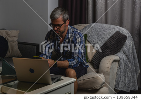 Frustrated man reacting to smartphone notification Frustrated man reacting to smartphone notification 139659344