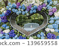 A cluster of tiny flowers, shrouded in purple, blue, and red mist, perfectly suited to the rain, will blossom into a magnificent flower. 139659558