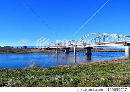 The Tōsui Bridge over the Tone River, as seen from the riverbed downstream on the left bank. The Tōsui Bridge over the Tone River, as seen from the riverbed downstream on the left bank. 139659727