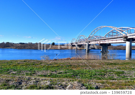 The Tōsui Bridge over the Tone River, as seen from the riverbed downstream on the left bank. The Tōsui Bridge over the Tone River, as seen from the riverbed downstream on the left bank. 139659728