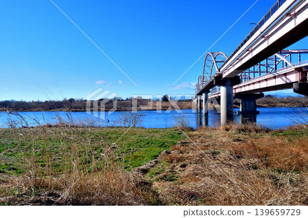 The Tōsui Bridge over the Tone River, as seen from the riverbed downstream on the left bank. The Tōsui Bridge over the Tone River, as seen from the riverbed downstream on the left bank. 139659729