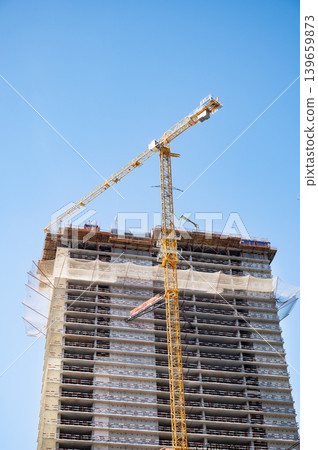 High-rise building under construction with tower crane, urban development and real estate concept High-rise building under construction with tower crane, urban development and real estate concept 139659873