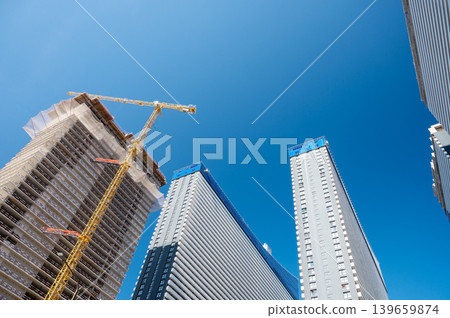 High-rise building under construction with tower crane, urban development and real estate concept 139659874
