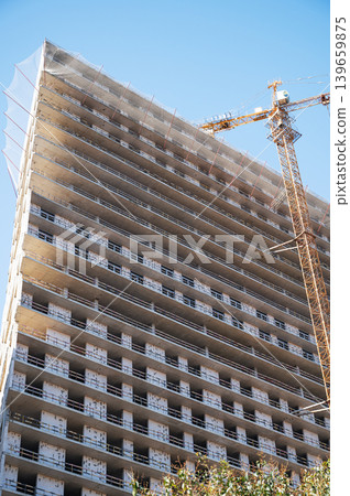 High-rise building under construction with tower crane, urban development and real estate concept High-rise building under construction with tower crane, urban development and real estate concept 139659875