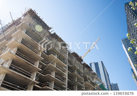 High-rise building under construction with tower crane, urban development and real estate concept High-rise building under construction with tower crane, urban development and real estate concept 139659876