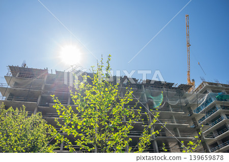 High-rise building under construction with tower crane, urban development and real estate concept High-rise building under construction with tower crane, urban development and real estate concept 139659878