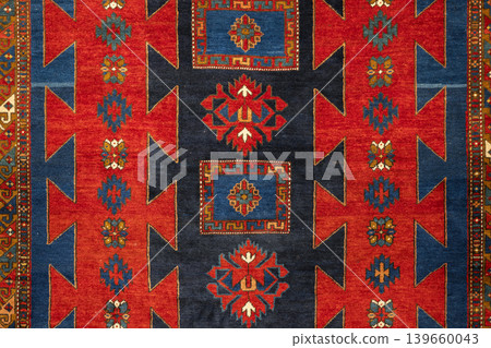 Close-up of a handwoven oriental Persian rug showing vibrant motifs Close-up of a handwoven oriental Persian rug showing vibrant motifs 139660043