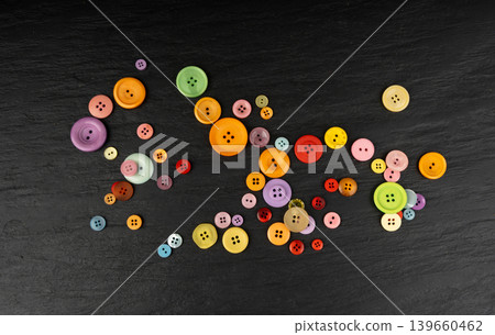 Multicolored sewing buttons. Plastic sew buttons of different colors and sizes Multicolored sewing buttons. Plastic sew buttons of different colors and sizes 139660462
