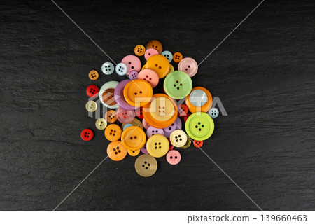 Multicolored sewing buttons. Plastic sew buttons of different colors and sizes Multicolored sewing buttons. Plastic sew buttons of different colors and sizes 139660463
