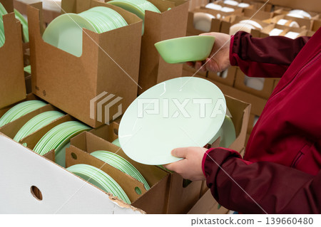 Green plates in crockery shop, dishware, tableware stack in store Green plates in crockery shop, dishware, tableware stack in store 139660480