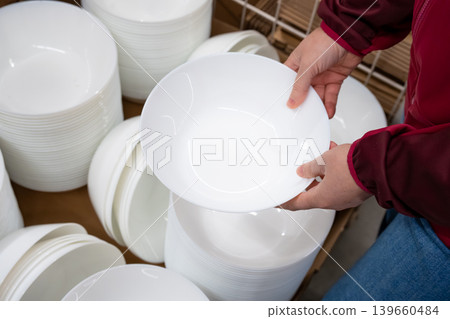Boxes of white plates in crockery shop, dishware, tableware stack in store Boxes of white plates in crockery shop, dishware, tableware stack in store 139660484