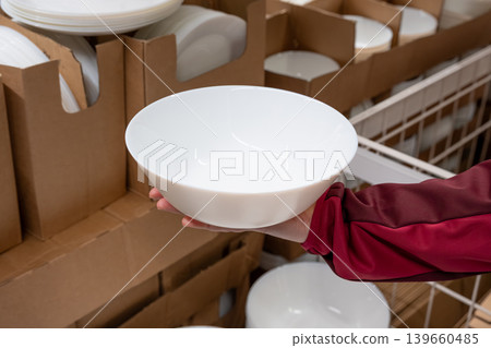 Boxes of white plates in crockery shop, dishware, tableware stack in store 139660485
