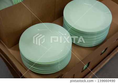 Boxes of mint green plates in crockery shop, dishware, tableware stack in store Boxes of mint green plates in crockery shop, dishware, tableware stack in store 139660490