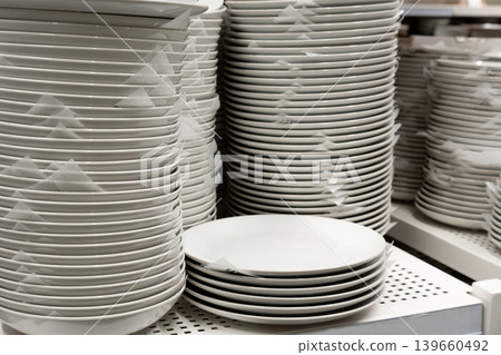 Boxes of white plates in crockery shop, dishware, tableware stack in store 139660492