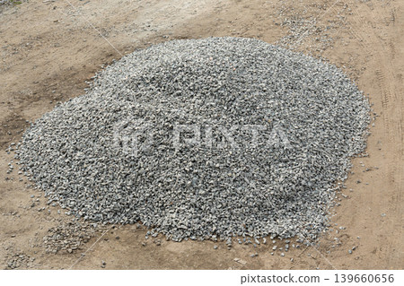 Construction gravel pile, crushed grey stone on ground Construction gravel pile, crushed grey stone on ground 139660656