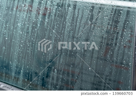 Drops on grey car surface after washing Drops on grey car surface after washing 139660703