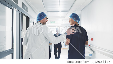 Doctor, nurse and talk while walk in hospital with advice, consult or communication with medical team. People, discuss or coaching for patient care, treatment and wellness after surgery with joke 139661147