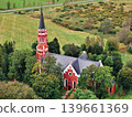 Halliste, Estonia September 25, 2025: Stensele Church showing its red brick architecture and tall spire, surrounded by green trees in a rural Swedish landscape 139661369