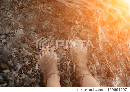 Feet water pebbles in clear ocean during relaxing summer beach vacation Feet water pebbles in clear ocean during relaxing summer beach vacation 139661397