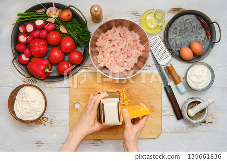 Preparing ingredients for a meal with fish, vegetables, herbs, and spices in the kitchen Preparing ingredients for a meal with fish, vegetables, herbs, and spices in the kitchen 139661836